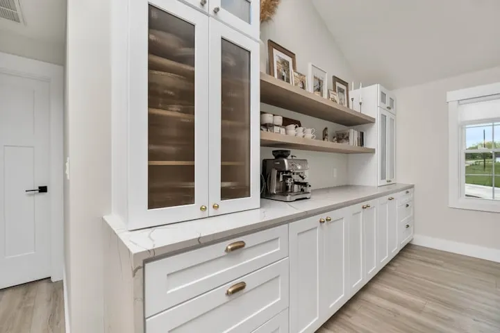 Modern kitchen remodel in Utah County, featuring white cabinets and marble countertops