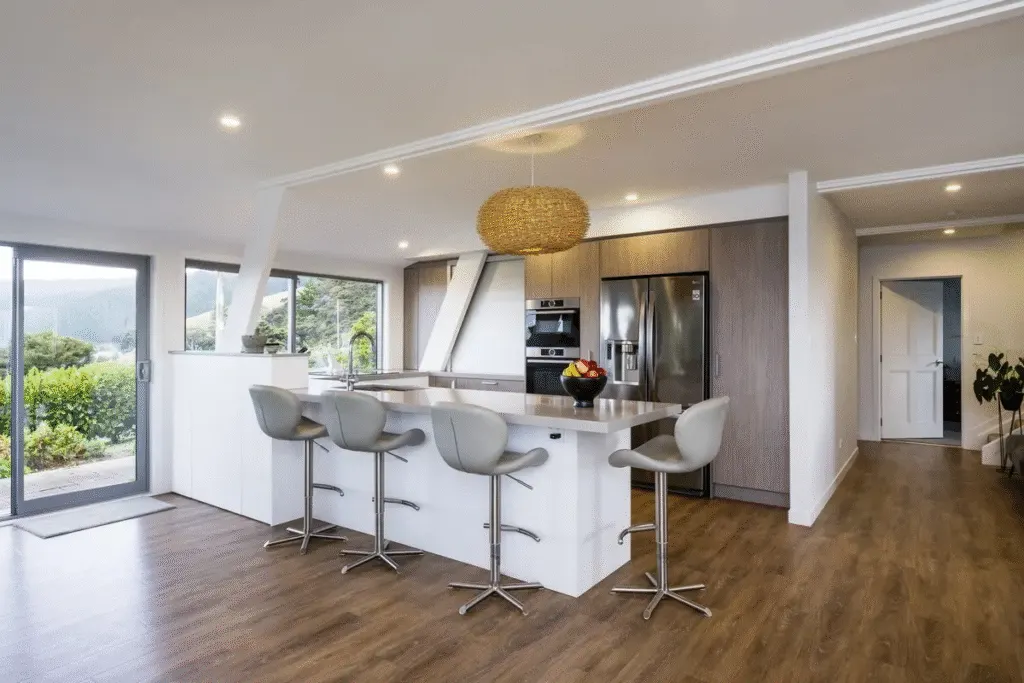 Modern kitchen with island and stainless appliances, in a home remodel in Utah County